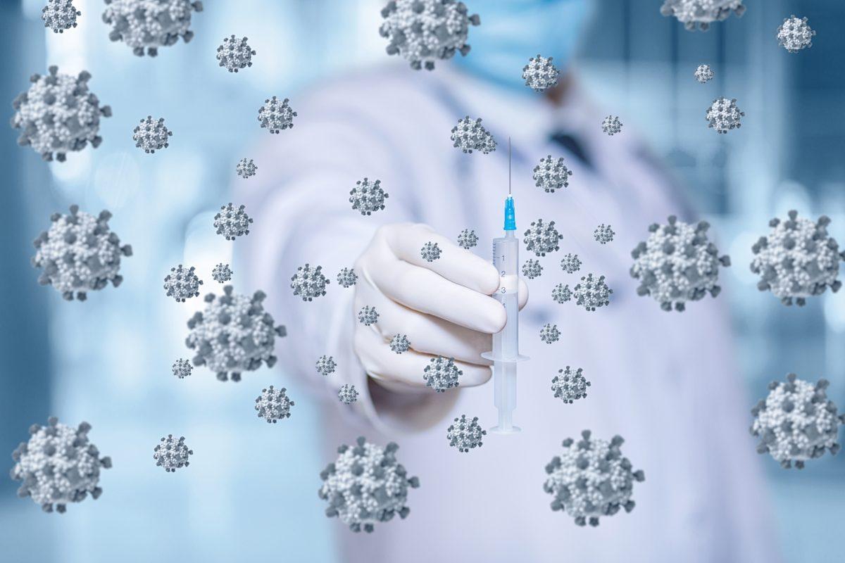 The concept of vaccination against the virus.Doctor with a syringe on a background of viruses.