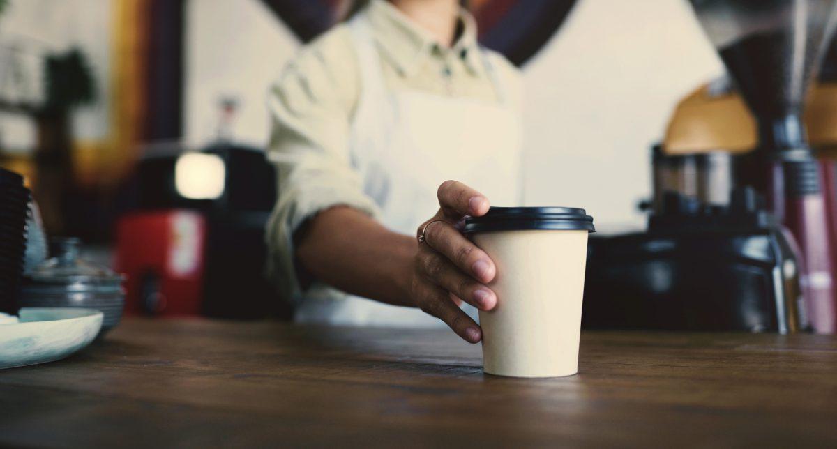 Barista, hands and coffee shop drink for POS, customer service POV and commerce or hospitality industry. Cashier, waiter or person with latte or order at point of sale for small business cafe or shop